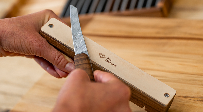 Precision sharpener with diamond-infiltrated leather